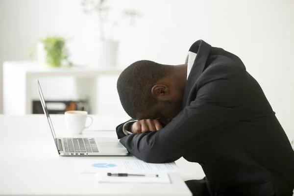 stock image African-american distraught businessman sleeping at workplace fe