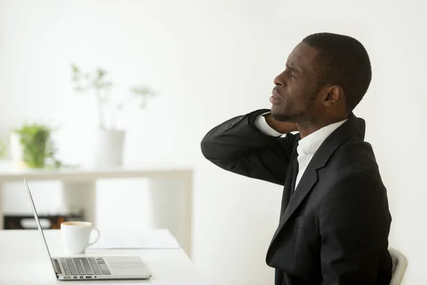 African-american businessman feels stiff neck joint pain after s — Stock Photo, Image