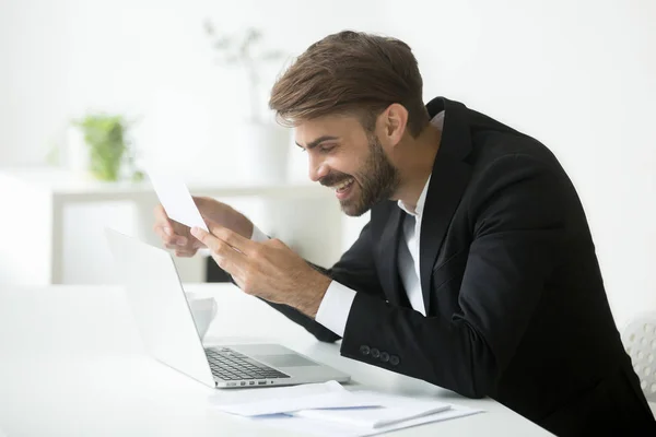 Excited successful businessman reading mail letter notice with g — Stock Photo, Image