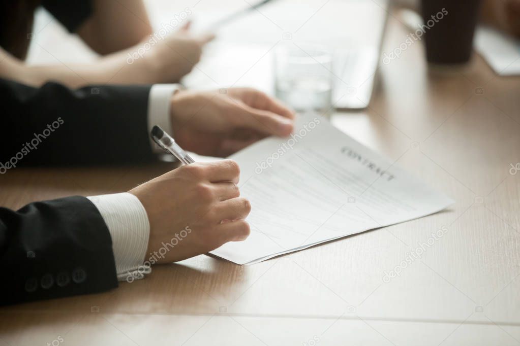 Businessman in suit signing business contract making deal, investor or executive putting signature on commercial paper, filling legal document in lawyers office, taking loan insurance, close up view