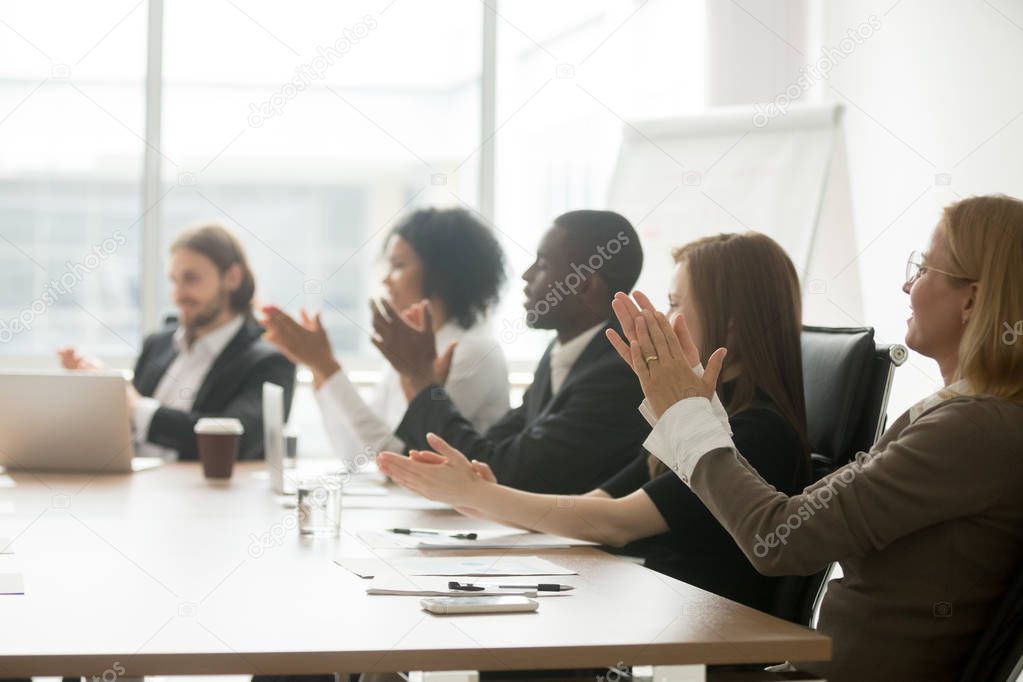 Multiracial business people applauding clapping hands at confere