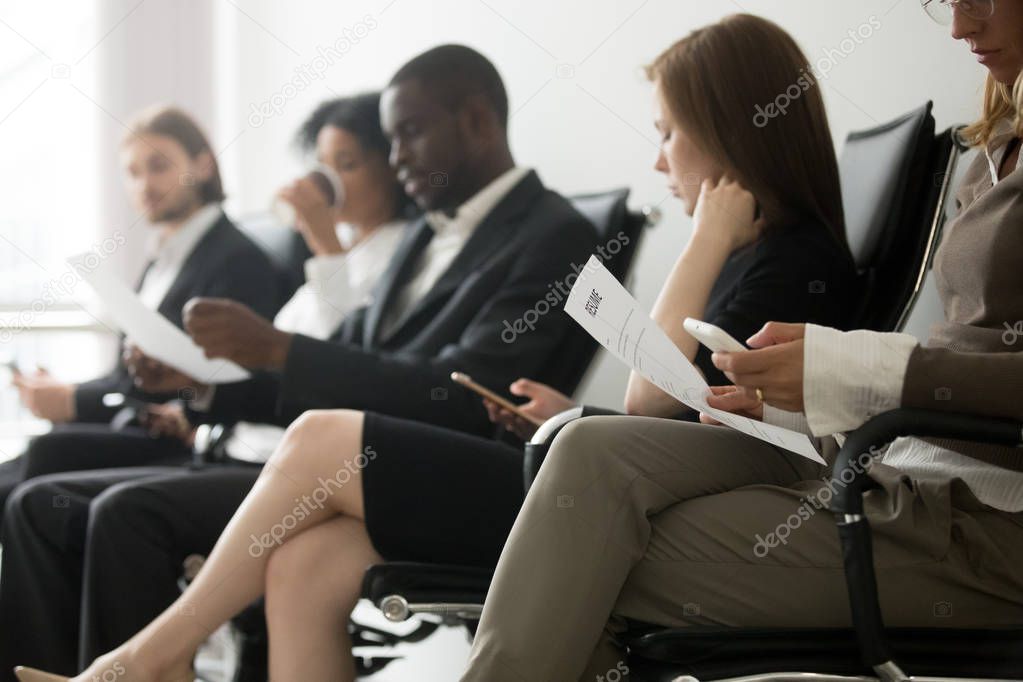 Multi-ethnic applicants sitting in queue waiting for job intervi