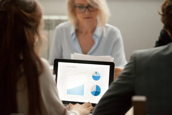 Female manager working with project statistics on laptop at meet — Stock Photo, Image