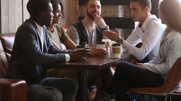 African and caucasian buddies making bet handshaking at coffeehouse meeting — Stock Video