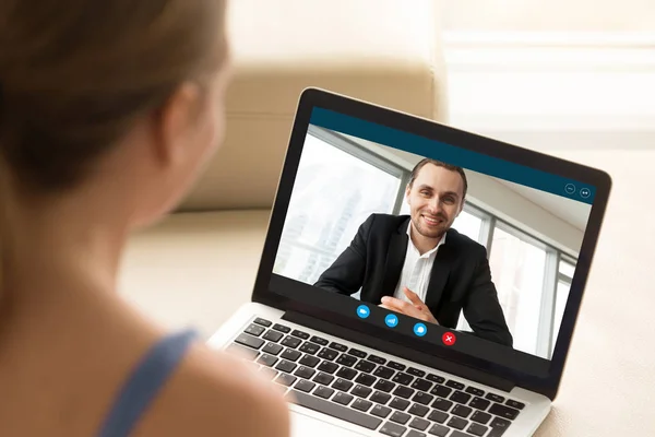 Young woman communicating with man via video call application.