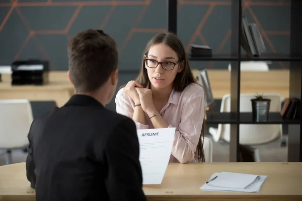 Confident millennial female applicant talking at job interview a