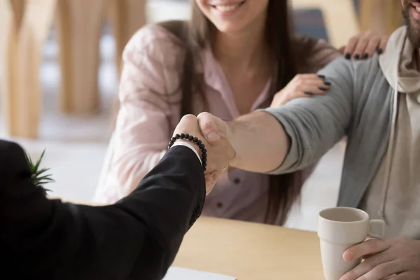 Couple customers handshaking businessman making successful deal,