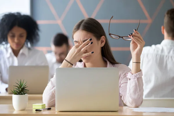 Woman taking off glasses tired of work, eyes fatigue concept — Stock Photo, Image