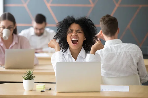 Happy excited african-american employee celebrating online win o — Stock Photo, Image