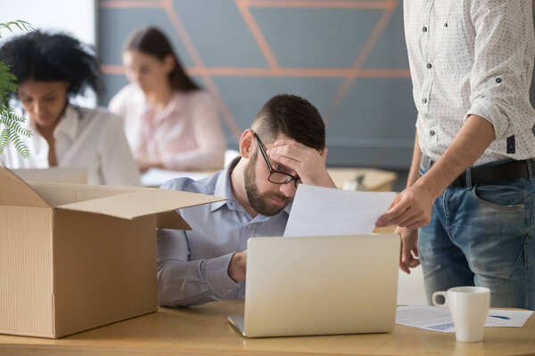 Frustrated upset employee receiving dismissal notice getting fir