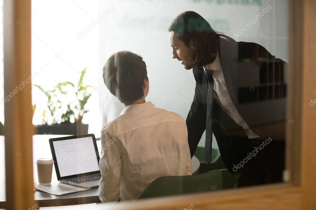 Businessman helping businesswoman brainstorming discussing email