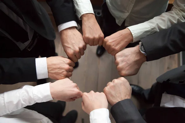 Business team put fists in circle, unity concept, top view — Stock Photo, Image