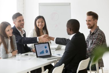 Satisfied multiracial businessmen handshaking after successful g clipart