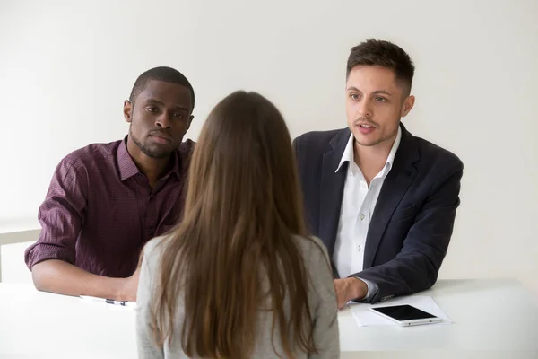 Serious african and caucasian hr managers interviewing female jo — Stock Photo, Image