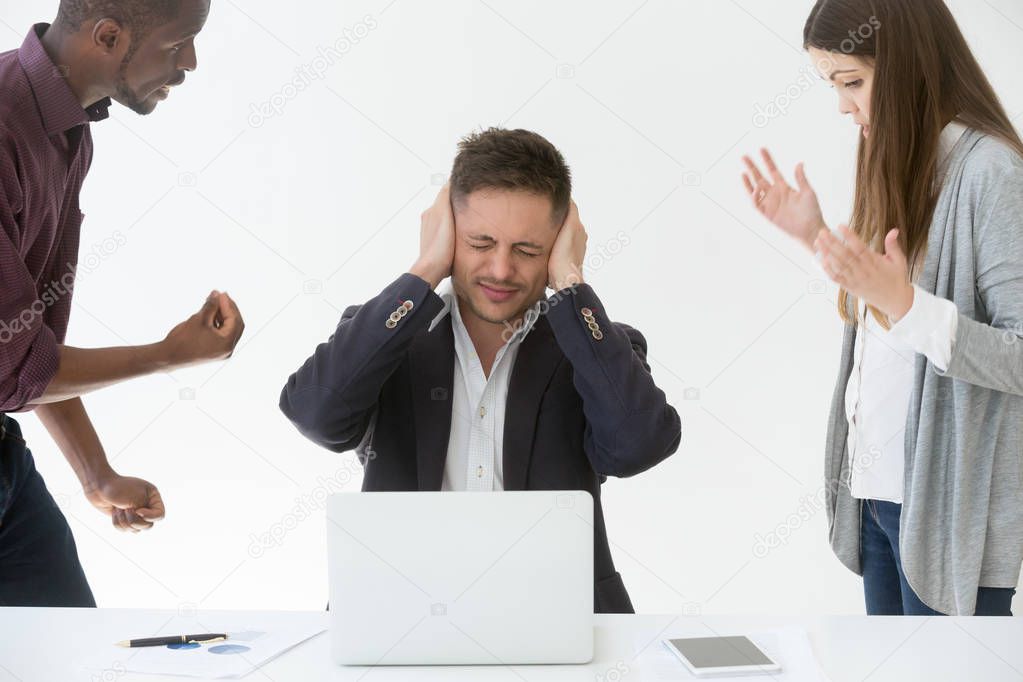 Tired from work or noise businessman closing ears with hands