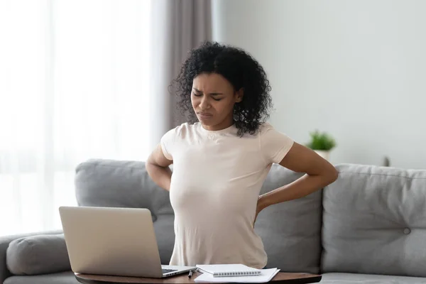 Unhealthy black woman stretching suffering from backache — Stock Photo, Image