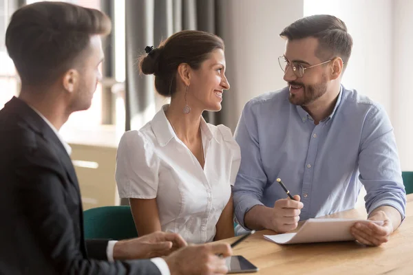 Happy young smiling couple discussing contract details