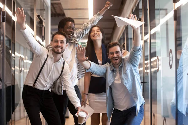 Portrait happy diverse employees celebrating business victory in hallway — Stock Photo, Image