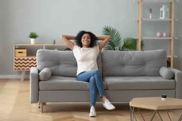 Happy black girl relaxing on cozy sofa at home — Stok Foto