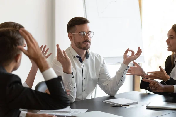 Peaceful businessman meditate ignoring annoying clients talking — Stock Photo, Image