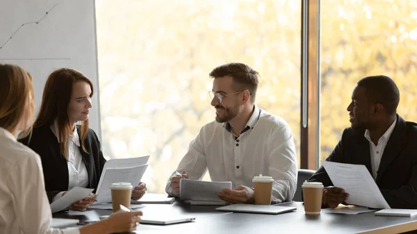 Millennial multiracial businesspeople consider paperwork in office — Stock Photo, Image