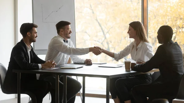 Smiling diverse partners handshake get acquainted at meeting — Stock Photo, Image