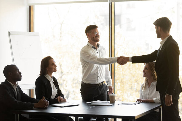 Happy businessmen handshake closing deal at negotiations