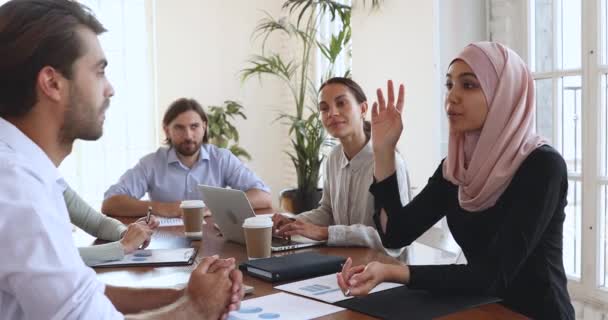 Asian muslim female client discussing project contract at group negotiations — Stock Video