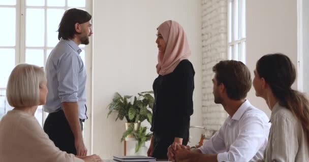 Male boss handshake promote female asian muslim worker, reward concept — Stock Video