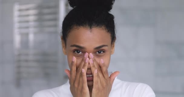 Feliz joven africana mujer tocando la piel facial mira a la cámara — Vídeo de stock