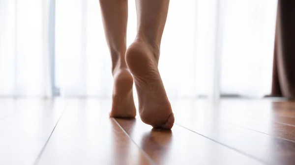 Female feet walking on warm heated floor close up view — ストック写真