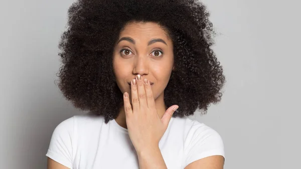 Head shot surprised African American girl covering mouth with hand — Stock Photo, Image