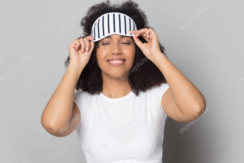 Head shot smiling African American girl wearing sleeping mask