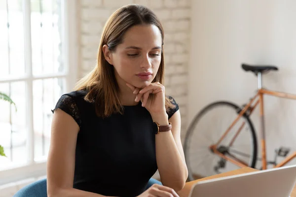 Focused young businesswoman busy with hard task.