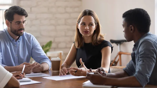 Concentrated teammates listening to coworker ideas at office. — Stock Photo, Image