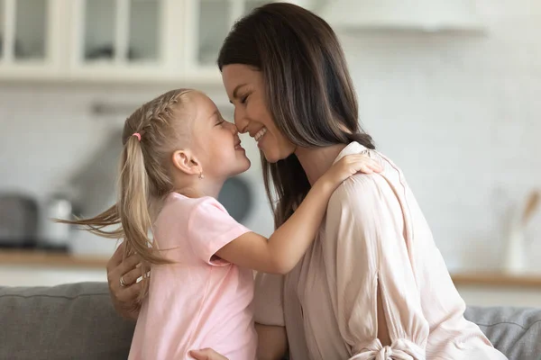 Little joyful kid girl touching noses with happy young mommy. — Stock Photo, Image