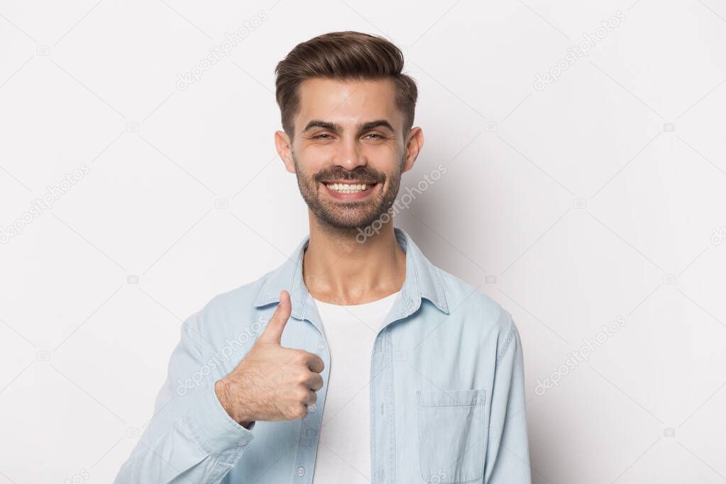 Close up portrait with smiling handsome bearded man thumbs up.