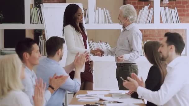 Velho gerente aperto de mão promovendo feliz jovem trabalhador africano no trabalho — Vídeo de Stock