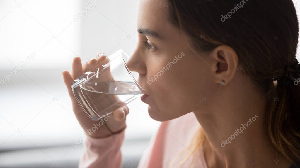 Close up of thirsty girl enjoying pure mineral water