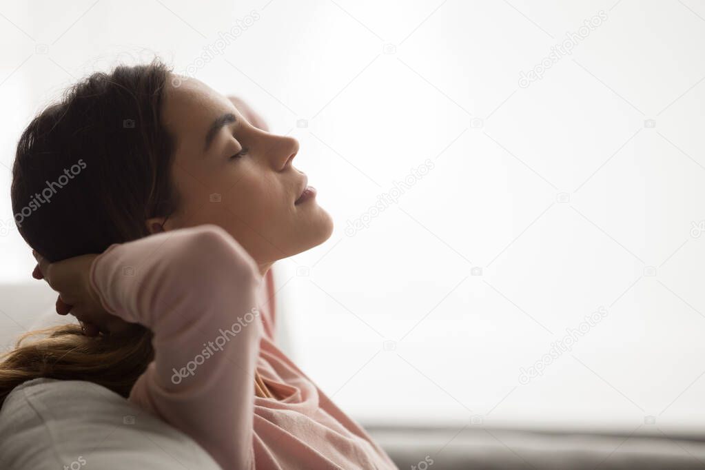 Close up of calm woman relaxing with eyes closed