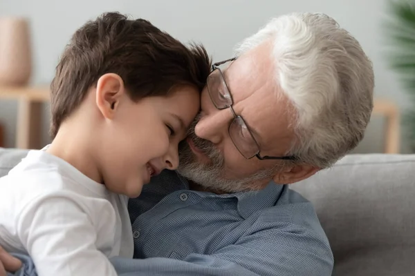 Grandfather hugging little grandson, expressing love and support close up — Stock Photo, Image