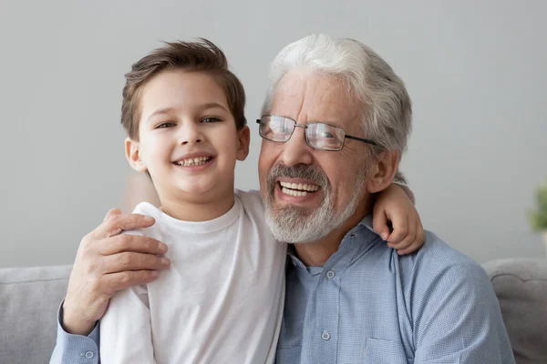 Head shot portrait smiling grandfather hugging cute little grandson — Stock Photo, Image