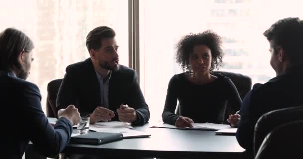 Male boss discuss project with multi ethnic team at meeting — Stock Video