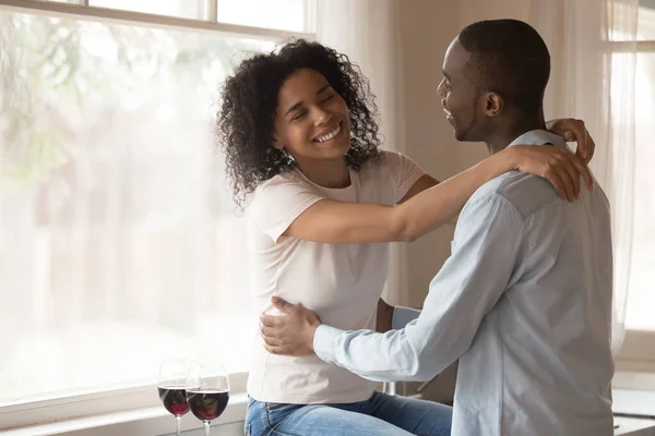 Happy biracial couple hug enjoying romantic date at home — ストック写真