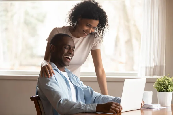 Happy biracial couple have fun using laptop together — Stock Photo, Image