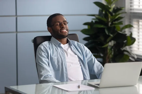 Calm african American employee relax in chair at work — Stock Photo, Image