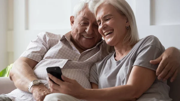 Bonding happy middle aged hoary family couple watching funny videos. — Stock Photo, Image