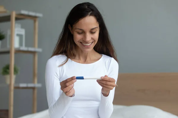 Woman makes ovulation or pregnancy test at home — Stock Photo, Image