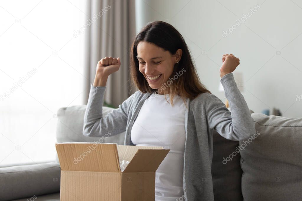 Cheery woman received long-awaited carton package feels happy