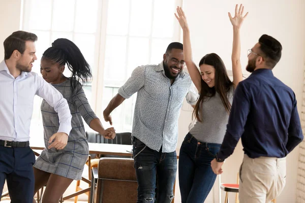 Felices colegas de carrera mixta organizaron fiesta de oficina el viernes por la noche . — Foto de Stock